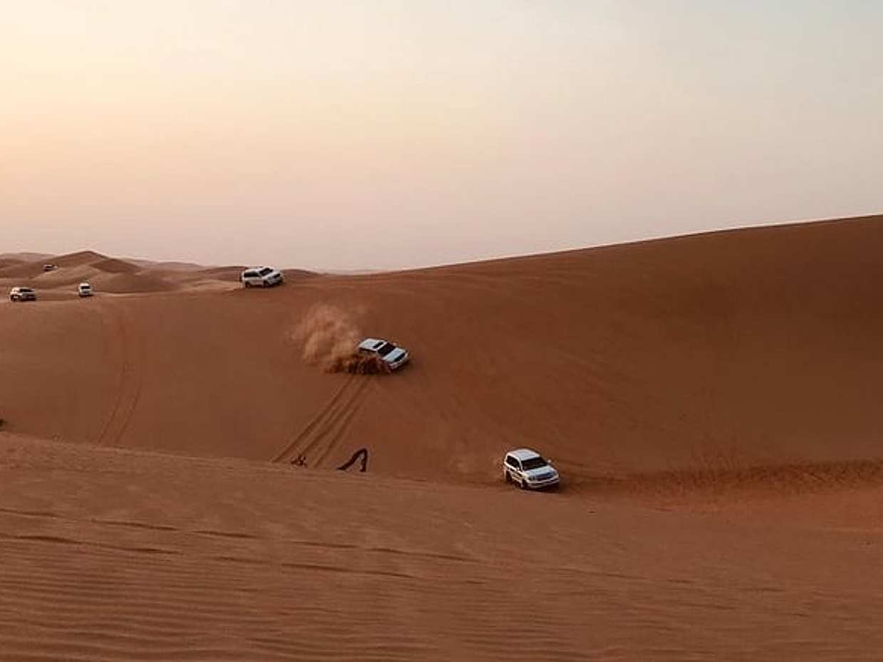 Abu Dhabi Desert safari with BBQ Dinner,Sandboarding & Camel ride
