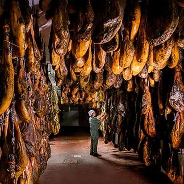 Tour through the Iberian ham drying room and Seville - pick up at the Hotel
